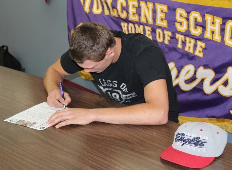 Quilcene High football standout Robert Comstock III signs the official letter of intent binding him to play for College of the Siskiyous in California's Community College system next year. Siskiyous is a feeder school that routinely sends players on to Division I programs.